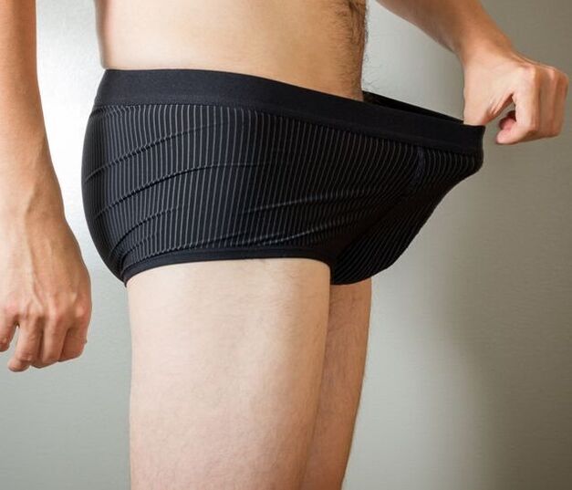 A man looks at his underwear after penis enlargement surgery